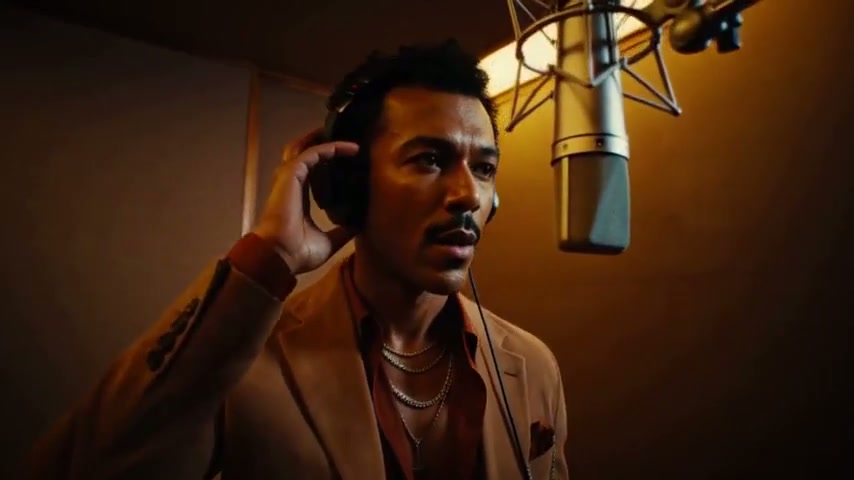 JOYTI performing in a golden-lit studio booth